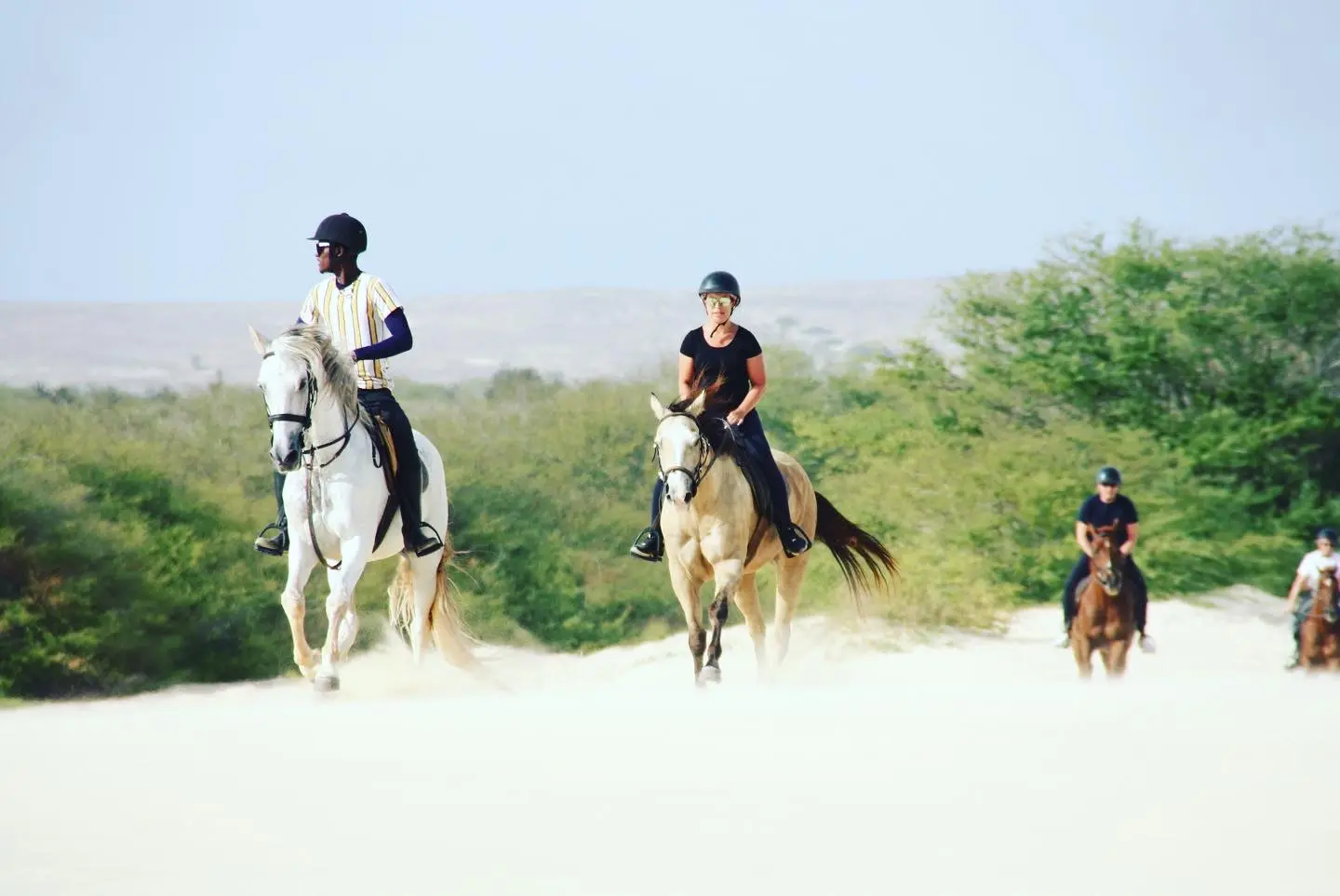 A guided group riding through the white dunes of Boa Vista