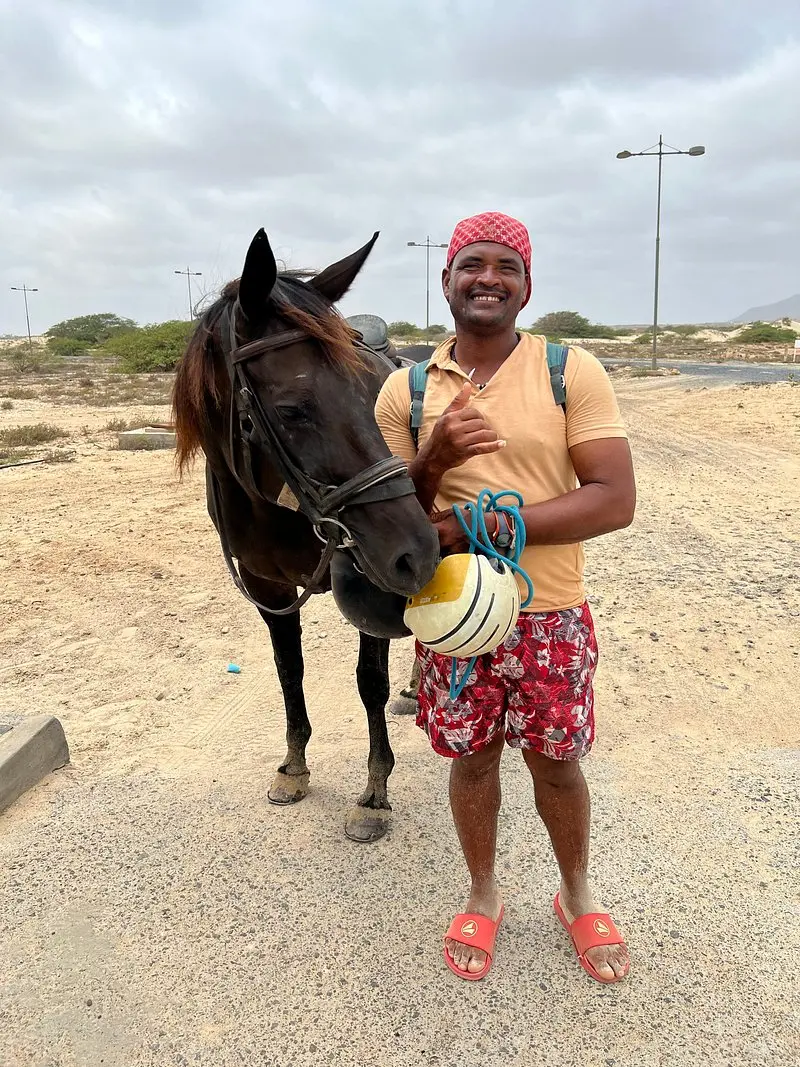 Sidnei, owner and guide of Boa Vista Horse Riding, standing beside one of his horses